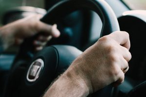 Close up of person learning how to hold the steering wheel at intensive driving school